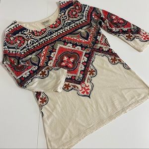 Intricate red and navy print cream top.